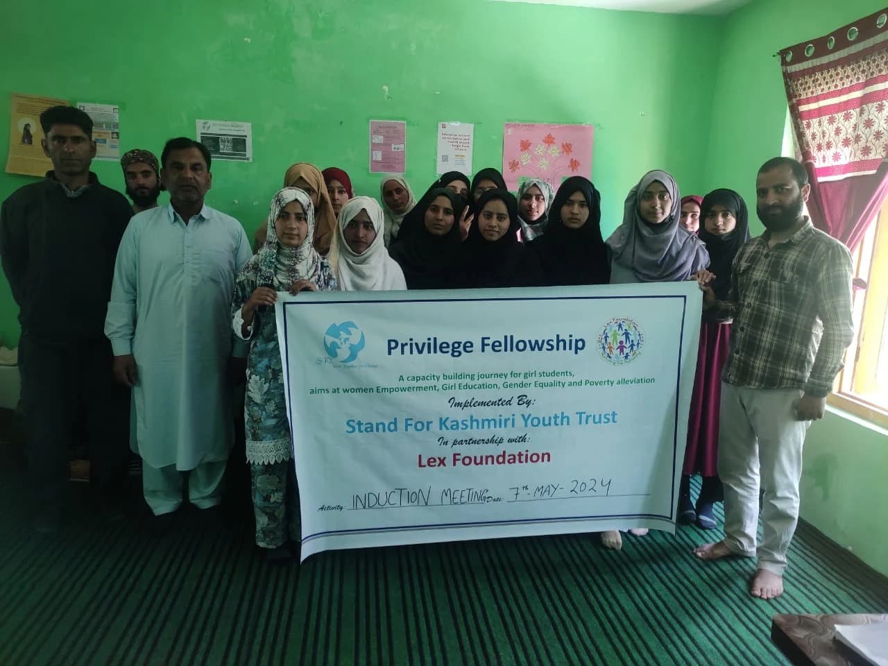 A group of girl students holding a Privilege Fellowship banner, a capacity-building programme for girl students run in partnership with Lex Foundation.