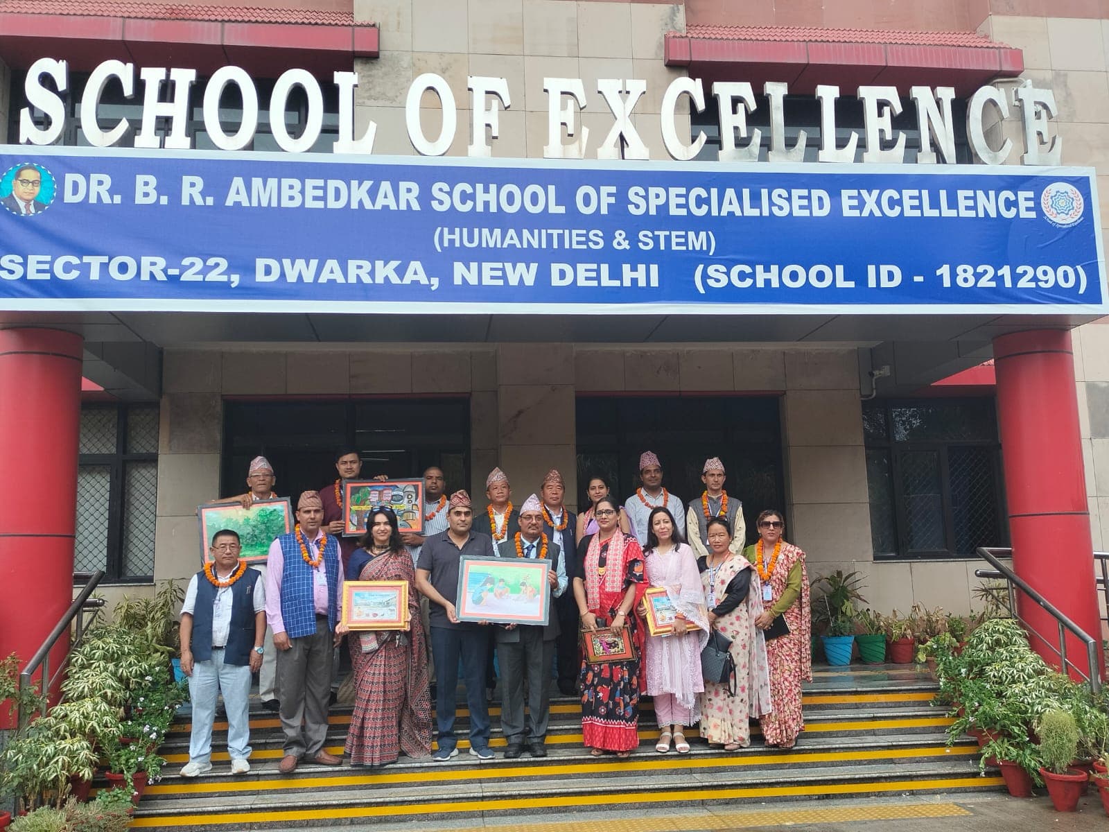 Delegates and school representatives posing outside Dr. B.R. Ambedkar School of Specialised Excellence, Sector-22, Dwarka, New Delhi.
